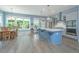 Spacious kitchen with island and stainless appliances flows into an eat-in dining area overlooking backyard at 2596 Hatch Dr, Johns Island, SC 29455