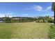 Scenic backyard with a lush lawn, landscaping, and a view of the tranquil lake at 267 Palmetto Walk Dr, Summerville, SC 29486