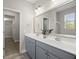 Bathroom featuring a double sink vanity, large mirror, and modern lighting fixtures at 267 Palmetto Walk Dr, Summerville, SC 29486