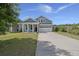 Charming blue two-story home with a well-manicured lawn and a two-car garage at 267 Palmetto Walk Dr, Summerville, SC 29486