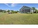 Beautiful home showcasing landscaped backyard and screened-in porch for outdoor enjoyment and relaxation at 267 Palmetto Walk Dr, Summerville, SC 29486