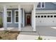 View of the home's front porch with white columns and a red front door at 267 Palmetto Walk Dr, Summerville, SC 29486
