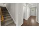 Hallway with carpeted stairs, hardwood flooring, and a welcoming entryway, offering a glimpse into the home's interior at 267 Palmetto Walk Dr, Summerville, SC 29486