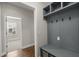 Hallway featuring hardwood floors and a built-in storage nook with cubbies and hooks at 267 Palmetto Walk Dr, Summerville, SC 29486
