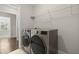 Well-lit laundry room showcasing modern washer and dryer set, complemented by sleek shelving at 267 Palmetto Walk Dr, Summerville, SC 29486