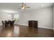 Spacious living area showcasing wood floors, a ceiling fan, and an adjacent dining space at 267 Palmetto Walk Dr, Summerville, SC 29486