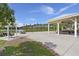 Beautiful outdoor space with a gazebo, swing, fire pit, and lake view; perfect for relaxing and entertaining at 267 Palmetto Walk Dr, Summerville, SC 29486