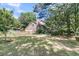 Picturesque backyard with a lush lawn, brick home, and fenced area, providing a tranquil outdoor retreat at 3 Birmingham Ct, Charleston, SC 29407