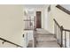 Spacious hallway featuring hardwood railing, carpet stairs, and several access doors at 3 Birmingham Ct, Charleston, SC 29407