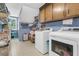 Efficient laundry room equipped with modern appliances, storage, and a bright window at 3 Birmingham Ct, Charleston, SC 29407