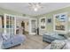 Bright living room with a ceiling fan and multiple windows that fill the room with natural light at 3 Birmingham Ct, Charleston, SC 29407
