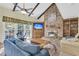 Living room with vaulted ceiling, brick fireplace, and large windows providing natural light at 3 Birmingham Ct, Charleston, SC 29407