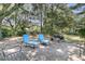 Back patio featuring lounge chairs and a grill for outdoor relaxation and entertaining in the shade at 3 Birmingham Ct, Charleston, SC 29407