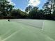 Well-maintained outdoor tennis court surrounded by mature trees, perfect for recreational play at 3 Birmingham Ct, Charleston, SC 29407