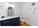 Clean bathroom with blue vanity, gold mirror, and white marble countertop at 3009 Palm Blvd, Isle of Palms, SC 29451