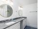 Elegant bathroom featuring dual sinks, marble countertops, modern fixtures and blue patterned floors at 3009 Palm Blvd, Isle of Palms, SC 29451