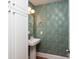 Stylish powder room featuring designer wallpaper, a pedestal sink, and elegant fixtures at 3009 Palm Blvd, Isle of Palms, SC 29451