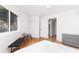 Bright bedroom with a large window, gray dresser, hardwood floors, and a ceiling fan at 3009 Palm Blvd, Isle of Palms, SC 29451