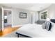 Well-lit bedroom with hardwood floors, a plush rug and a view from a bright window at 3009 Palm Blvd, Isle of Palms, SC 29451