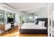 Bright bedroom featuring a private balcony, sliding glass doors, and hardwood floors at 3009 Palm Blvd, Isle of Palms, SC 29451