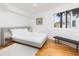 Bright bedroom with a large window, a full bed and hardwood floors at 3009 Palm Blvd, Isle of Palms, SC 29451