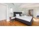 Bright bedroom featuring unique wallpaper, hardwood floors, and modern furnishings at 3009 Palm Blvd, Isle of Palms, SC 29451