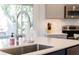 Close-up on kitchen with stainless steel sink and appliances, and gray cabinets at 3009 Palm Blvd, Isle of Palms, SC 29451