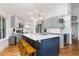 Bright kitchen featuring a center island with seating, modern lighting, and stainless steel appliances at 3009 Palm Blvd, Isle of Palms, SC 29451