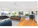 Bright living room with wood floors, modern decor, and panoramic windows overlooking the outdoors at 3009 Palm Blvd, Isle of Palms, SC 29451