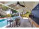 Inviting outdoor pool with a covered patio, ceiling fans, and bar, creating an ideal space for relaxation and entertainment at 3009 Palm Blvd, Isle of Palms, SC 29451