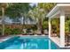 Enjoy the tranquility of this pristine swimming pool with outdoor seating and lush landscaping, creating a relaxing outdoor oasis at 3009 Palm Blvd, Isle of Palms, SC 29451