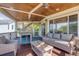 Comfortable screened porch features a cozy seating area and a dining table for outdoor entertaining and relaxing at 3009 Palm Blvd, Isle of Palms, SC 29451