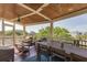 Inviting screened porch features a dining table and comfortable seating for relaxing and enjoying the outdoors at 3009 Palm Blvd, Isle of Palms, SC 29451