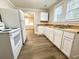 Cozy kitchen featuring stainless steel sink, white cabinets, and open layout at 307 Mill St, Walterboro, SC 29488