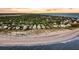 Aerial view of a coastal community with beautiful homes lining the beach and overlooking the ocean at 3128 Palmetto Blvd, Edisto Island, SC 29438