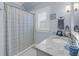Charming bathroom with granite countertop, window shutter, and decorative shower curtain at 3128 Palmetto Blvd, Edisto Island, SC 29438