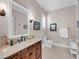 Bathroom with dark wood cabinets, marble countertops, and modern fixtures, offering a blend of luxury and functionality at 3128 Palmetto Blvd, Edisto Island, SC 29438