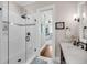 Bright bathroom featuring a glass walk-in shower with sleek fixtures and a white tiled wall with decorative accent at 3128 Palmetto Blvd, Edisto Island, SC 29438
