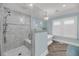 Modern bathroom with white marble shower, soaking tub, and elegant herringbone wood flooring at 3128 Palmetto Blvd, Edisto Island, SC 29438