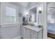 Well-lit bathroom featuring granite countertop, bright window shutter, and modern fixtures at 3128 Palmetto Blvd, Edisto Island, SC 29438