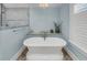 Elegant bathroom with freestanding tub, natural light, and modern design elements at 3128 Palmetto Blvd, Edisto Island, SC 29438