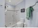Bathroom featuring a glass door shower and blue accent wall at 3128 Palmetto Blvd, Edisto Island, SC 29438