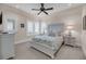 Bright bedroom with ceiling fan, side tables and bright window shutters at 3128 Palmetto Blvd, Edisto Island, SC 29438