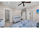Bedroom with ceiling fan, crib, closet, and en-suite entrance at 3128 Palmetto Blvd, Edisto Island, SC 29438