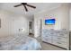 Bright bedroom featuring a ceiling fan, television, and ensuite bathroom at 3128 Palmetto Blvd, Edisto Island, SC 29438