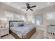 Cozy bedroom with ceiling fan, and bright window shutters perfect for relaxation at 3128 Palmetto Blvd, Edisto Island, SC 29438
