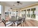 Covered deck featuring an outdoor dining table, ceiling fans, and water views at 3128 Palmetto Blvd, Edisto Island, SC 29438