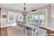 Bright dining room featuring a decorative chandelier, seating for eight, and sliding glass doors leading to a deck at 3128 Palmetto Blvd, Edisto Island, SC 29438