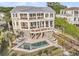 Stunning three-story home with private pool, outdoor lounge, and picturesque fenced-in yard at 3128 Palmetto Blvd, Edisto Island, SC 29438