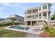 Beautiful multi-story home with an outdoor swimming pool and spacious lounging area perfect for entertaining at 3128 Palmetto Blvd, Edisto Island, SC 29438